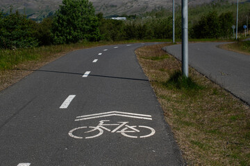 Fototapeta premium Bicycle lane in Mosfellsbær, Iceland surrounded by scenic greenery and countryside