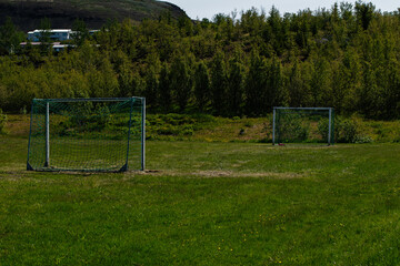 Fototapeta premium Outdoor soccer goals on a lush field in Mosfellsbær, Iceland