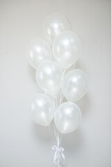 white pearl balloons with helium in a bunch for a holiday