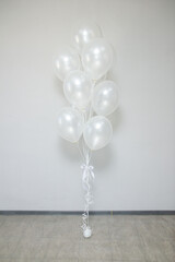 white pearl balloons with helium in a bunch for a holiday