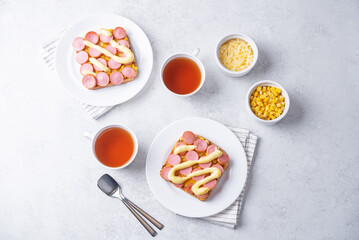 Cheese corn sausages baked sandwich in a plate