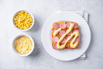 Cheese corn sausages baked sandwich in a plate