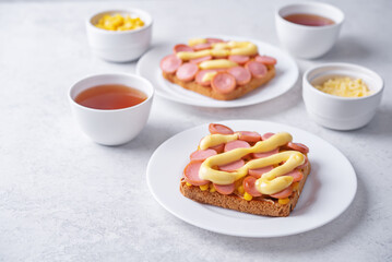 Cheese corn sausages baked sandwich in a plate