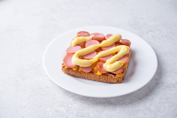 Cheese corn sausages baked sandwich in a plate