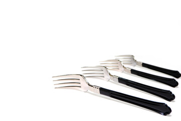 Close up shot of silver fork layered together side by side with white background, Food conceptual...