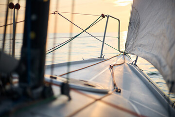 Sailing regatta in the Gulf of Finland at sunset, sailing yacht competing in a race, splashing...
