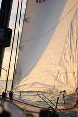 Sailing regatta in the Gulf of Finland at sunset, sailing yacht competing in a race, splashing...