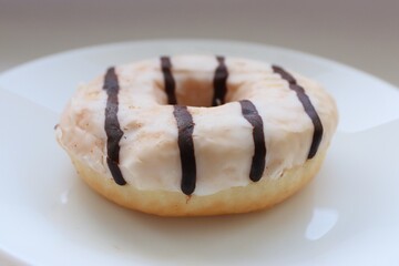  A glazed milk and chocolate doughnut with fillings on a white background, 
