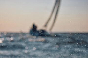 Sailing regatta in the Gulf of Finland at sunset, sailing yacht competing in a race, splashing...