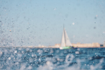 Sailing regatta in the Gulf of Finland at sunset, sailing yacht competing in a race, splashing...