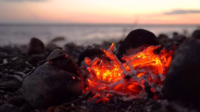  red coals of the fire burn in the night.