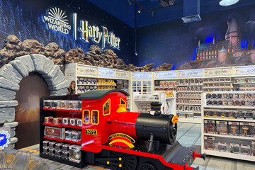 Fototapeta premium May 18, 2025, Dubai, UAE: Harry Potter-themed section inside Hamleys toy store in Dubai, filled with plush toys, collectibles, wizard decor. Magical retail experience for fans