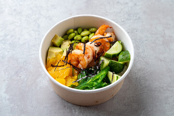 Colorful shrimp bowl features succulent shrimp, crisp cucumbers, creamy avocado, fresh edamame, and...