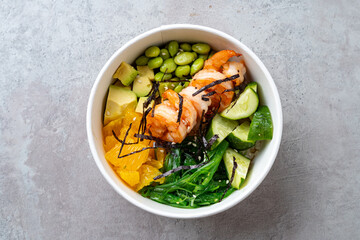 A colorful bowl brimming with succulent shrimp, crisp edamame, vibrant greens, and juicy citrus....