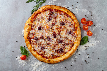 Mouthwatering pizza features a golden crust topped with melted cheese, juicy tomatoes, and herbs, resting on a textured surface sprinkled with flour and spices