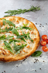 Warm flatbread showcases a mouth-watering combination of savory toppings, including fresh greens, succulent fish, and juicy cherry tomatoes, inviting anyone nearby to indulge