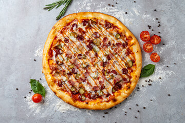 Vibrant pizza is adorned with unique toppings like sliced pickles and tomatoes, reflecting a...