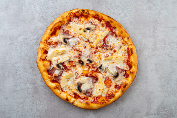 A perfectly baked pizza features melted cheese, savory toppings of mushrooms and artichokes, inviting all to enjoy its delicious flavors and crispy crust in a cozy setting