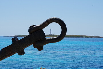 Fototapeta premium Lighthouse in the distance through an anchor loop