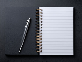 Notebook with pen on black background