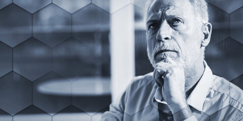 Thoughtful senior businessman, geometric pattern