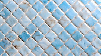 Textured ceramic wall with blue and white mosaic tiles in a quatrefoil pattern, glossy handcrafted surface ideal for backgrounds, interior design, or architectural decoration

