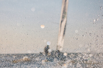 Sailing regatta in the Gulf of Finland at sunset, sailing yacht competing in a race, splashing...