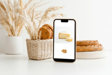 Artisanal cheese and baked goods displayed on online store interface featuring crisp clean design. Setting features neutral rich colors with modern aesthetic