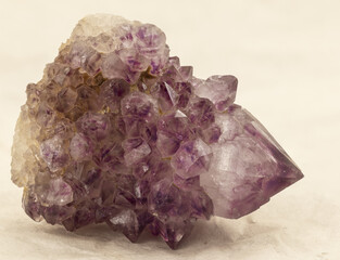 Macro shot of a raw amethyst crystal featuring vibrant violet terminations and detailed faces. A perfect natural specimen for mineral collectors, gem enthusiasts, and educational or spiritual purposes