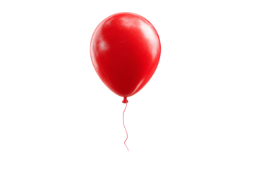 A red balloon is floating in the air