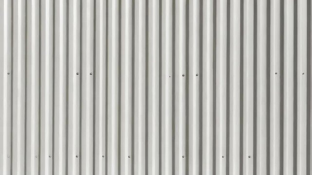 Neutral corrugated metal surface texture with rivets, provides a background or graphic resource for construction industry themed projects