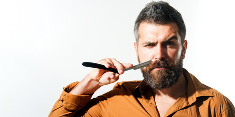 Barbershop accessories. Bearded man with straight razor. Beard care. Portrait of stylish man with...
