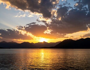 Sunset over a lake, dramatic clouds