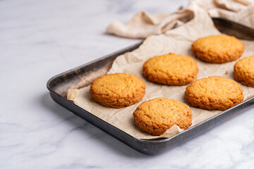 Homemade peanut or almond butter cookies or oatmeal cookies on white kitchen background. High quality photo