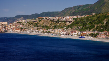 Obraz premium Panoramic view of Scilla, Calabria, a popular tourist destination in Southern Italy, featuring its beach, hotels, and the prominent Ruffo Castle