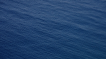 Small waves gently moving on the surface of the deep blue sea near Scilla, Calabria, Italy