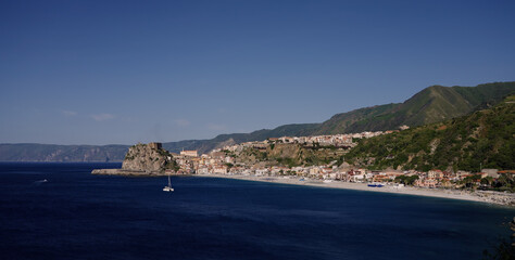Fototapeta premium Panoramic view of Scilla, Calabria, with the Ruffo Castle perched on a rocky promontory, overlooking the Tyrrhenian Sea
