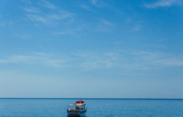 Boat on the sea, blue sky, calm, light clouds, Adriatic coast