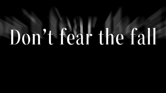 Don't fear the fall text displayed in white against a dark black background with blurred effect .