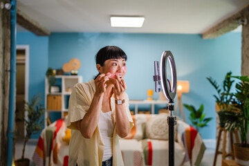 Japanese woman live streaming to review makeup and cosmetic products
