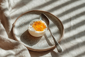 Elegant food concept with egg on rustic ceramic plate