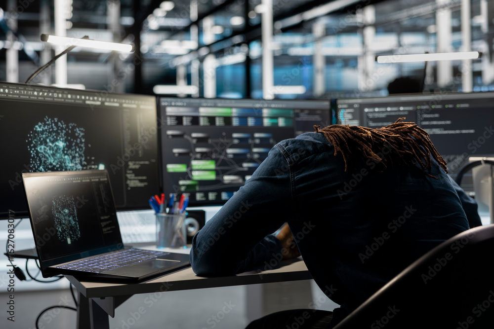 Poster exhausted server farm engineer falls asleep while looking at data analysis graph to reduce equipment