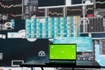 Isolated copy space screen running on laptop next to fintech annual reports, ensuring a strategy...