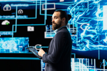 Young entrepreneur works on implementing AI brain system for deep learning, employing neural network and cybernetics for development. Driving smart technology and algorithmic thinking.