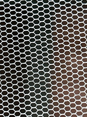 close-up of a mosquito net, revealing the precise geometry of its design.