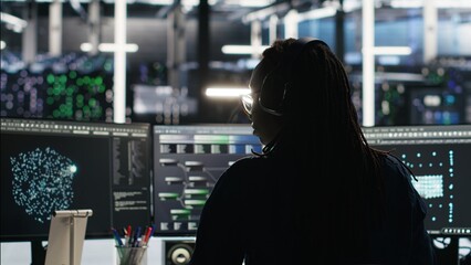 Server room programmer interpreting AI generated data analytics graphs, putting on headphones. Data...