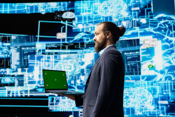 Business administrator uses mockup display next to AI neural networks system, practicing machine...