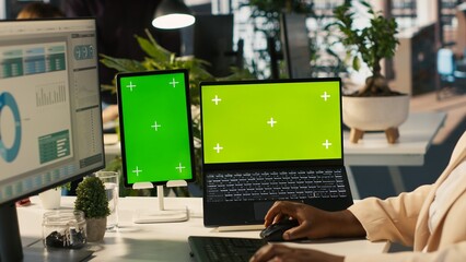 Mockup tablet and laptop in office used by employee working on company administrative tasks. Chroma...