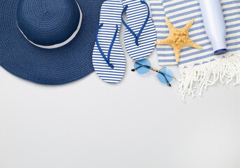 Blue beach accessories on color background, top view. Copy space for text