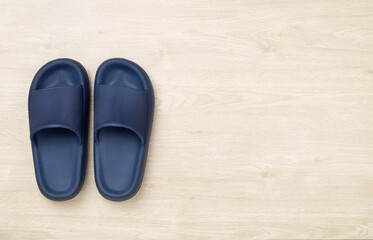 Blue sandals on wooden background,top view